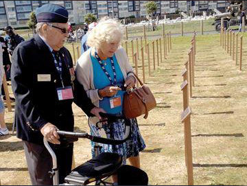 Squadron Leader Jack Malone CD and Hazil Malone at the Juno Beach Memorial. Each of the 359 tribute markers shown (made from Canadian maple) represents a Canadian who died on D-Day. The markers will remain on display for visitors until Remembrance Day 2014.